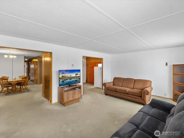 a view of a dining room with furniture and chandelier