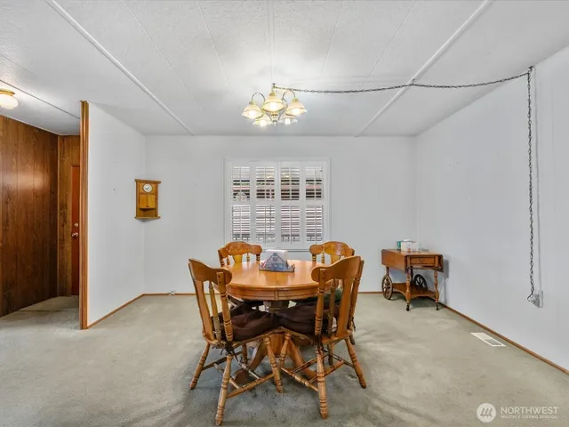 a view of a dining room with furniture and chandelier