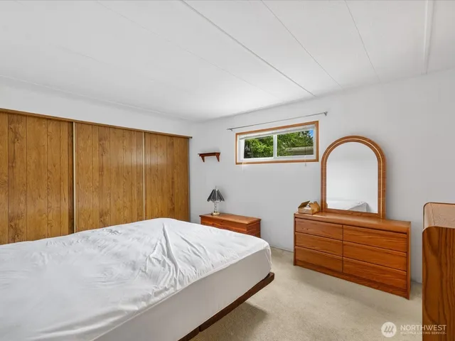 a bedroom with two bed and a closet