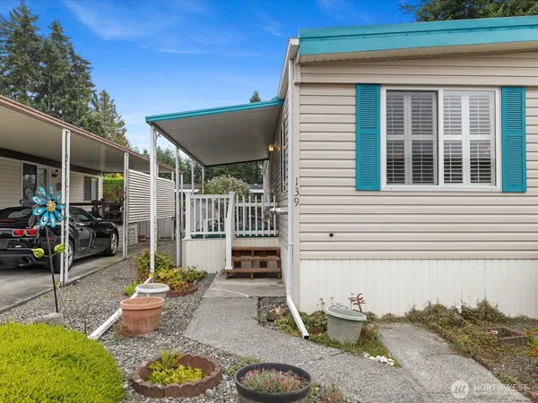a house view with a sitting space fire pit and outdoor seating