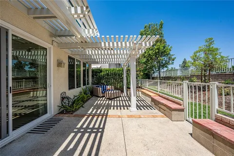 a view of a patio with a table chairs and a potted plant