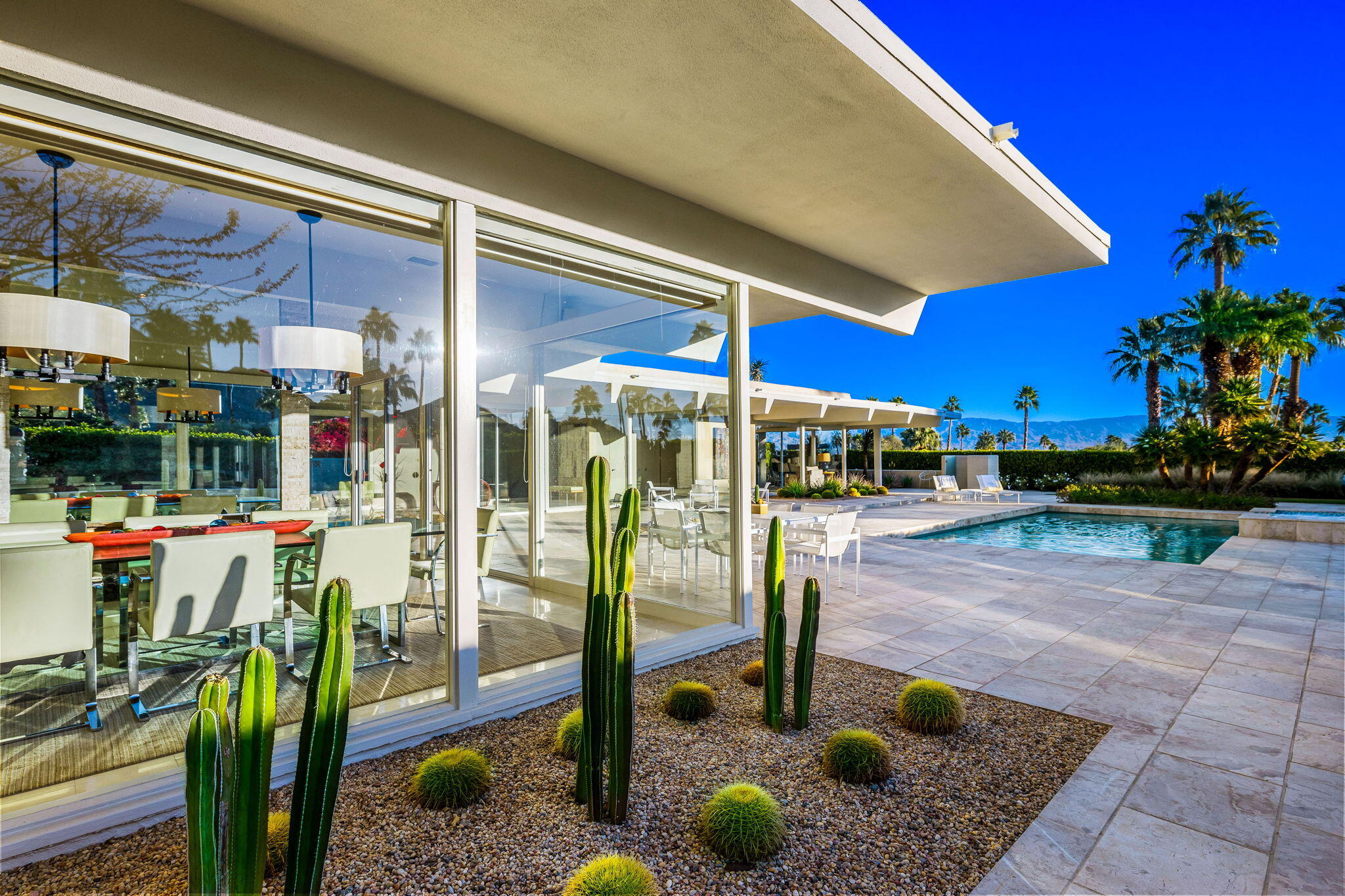 40780 Thunderbird Road Rancho Mirage, CA 92270 - Photo 12 of 29 a view of a swimming pool with a porch in front of it
