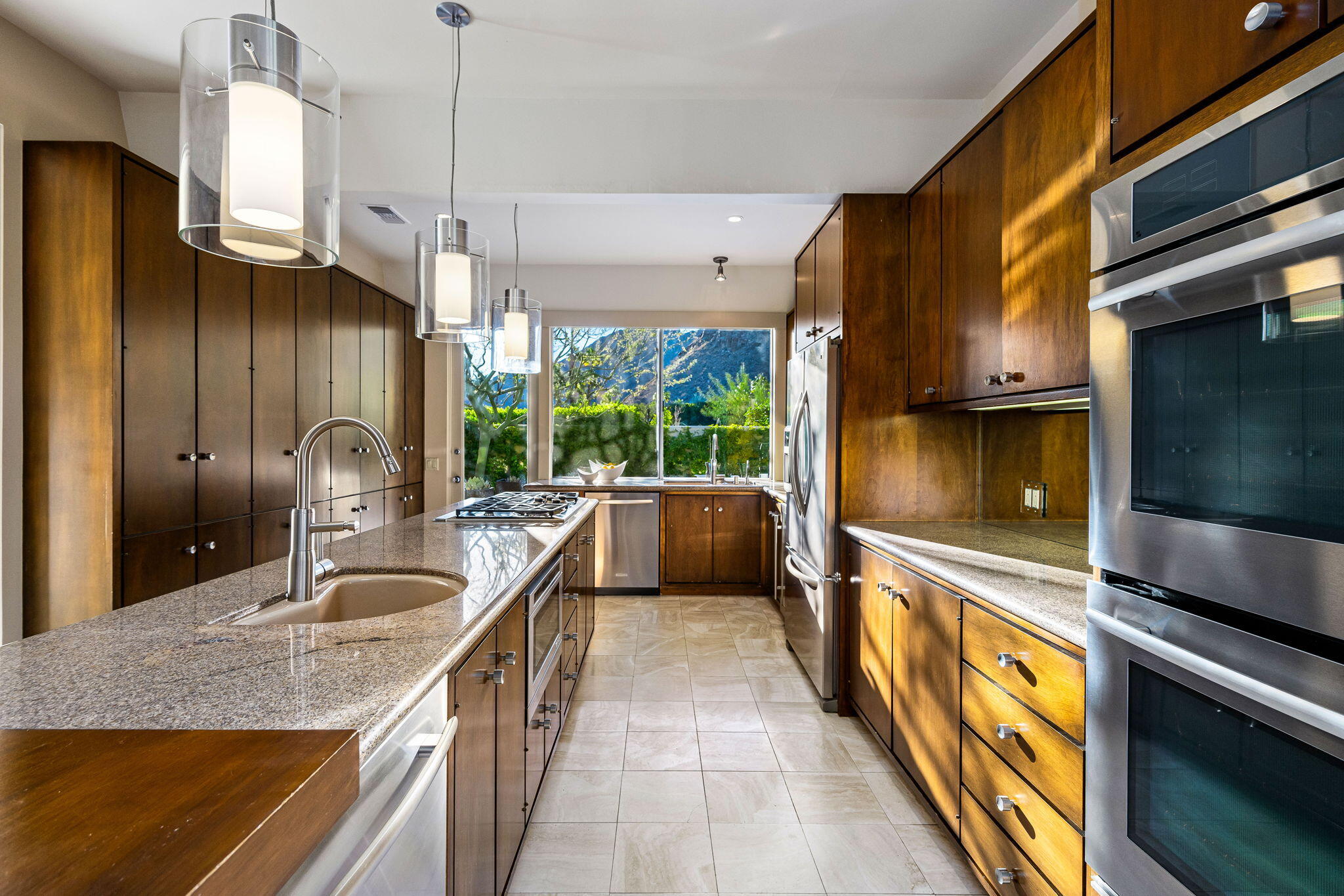 40780 Thunderbird Road Rancho Mirage, CA 92270 - Photo 14 of 29 a kitchen with granite countertop a sink a counter top space stainless steel appliances and cabinets