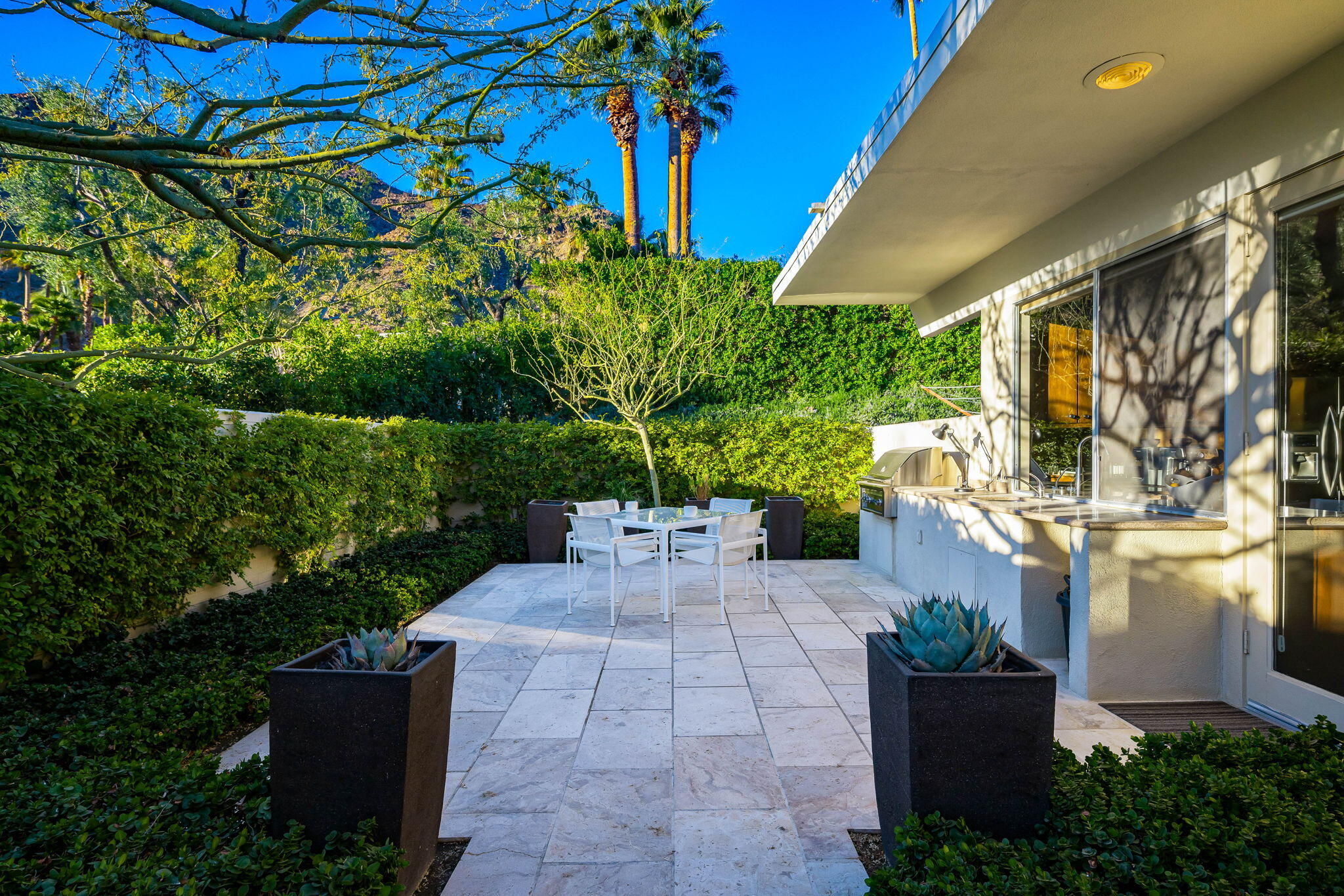 40780 Thunderbird Road Rancho Mirage, CA 92270 - Photo 15 of 29 a view of a patio with table and chairs and potted plants