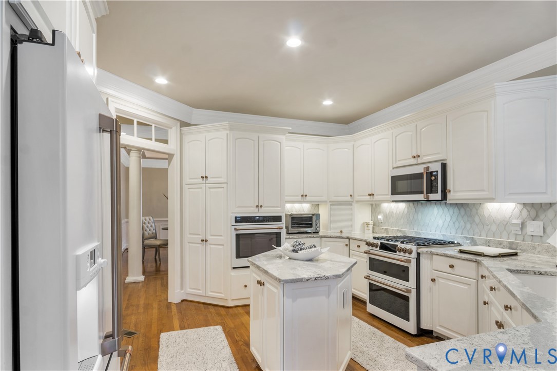 2509 Nathaniell Powell Road Williamsburg, VA 23185 - Photo 16 of 53 a kitchen with white cabinets and stainless steel appliances