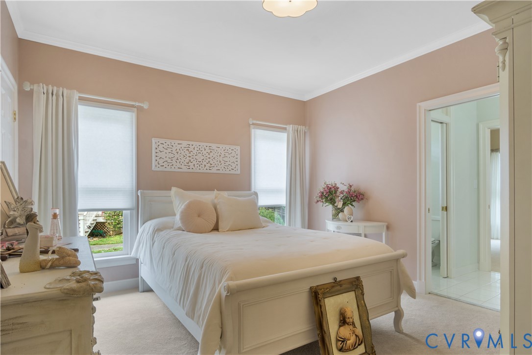 2509 Nathaniell Powell Road Williamsburg, VA 23185 - Photo 25 of 53 a bedroom with a large bed and a potted plant