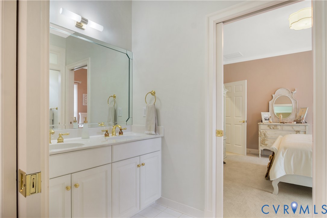 2509 Nathaniell Powell Road Williamsburg, VA 23185 - Photo 29 of 53 a en suite bathroom with a double vanity sink and a mirror