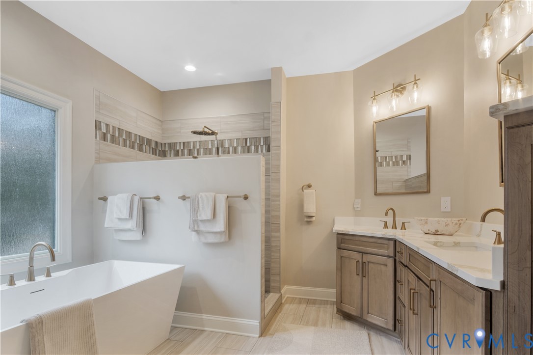2509 Nathaniell Powell Road Williamsburg, VA 23185 - Photo 37 of 53 a spacious bathroom with a double vanity sink mirror and bathtub