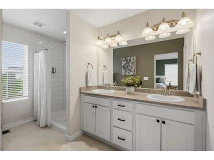 a bathroom with a shower curtain and a window