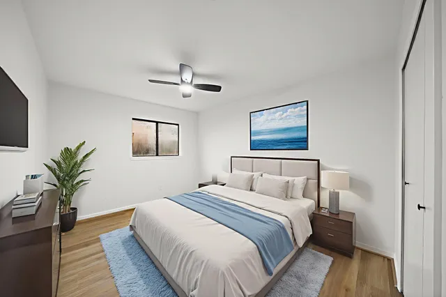 a bedroom with a large bed and a chandelier