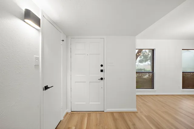 a view of a hallway with wooden floor