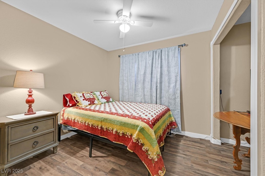 820 Manor Shores Road Henderson, NV 89002 - Photo 25 of 35 Bedroom featuring a ceiling fan, baseboards, and wood finished floors