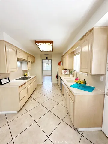 a kitchen with a stove a sink and a refrigerator