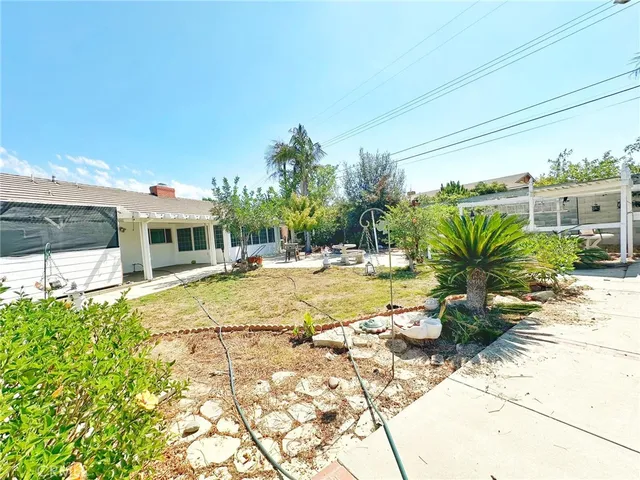 a front view of a house with a tree