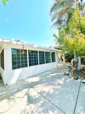 a backyard of a house with table and chairs
