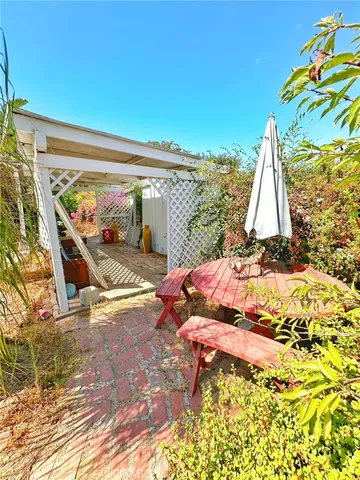 a backyard of a house with a tree and plants