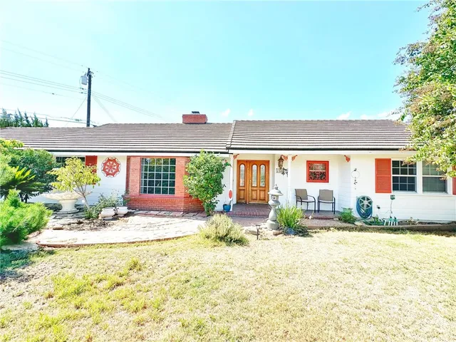 a house view with swimming pool and outdoor seating