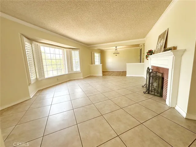 a view of a livingroom with a fireplace and a window