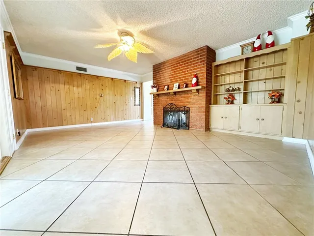 a view of an empty room with cabinet and a window