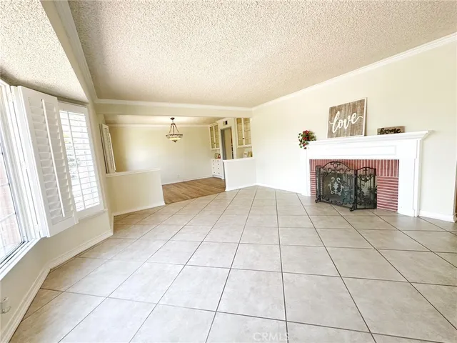 a view of empty room with cabinet and fireplace