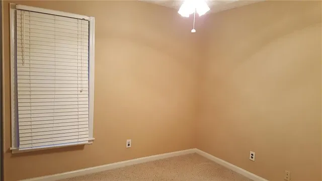 a view of wooden wall and a window