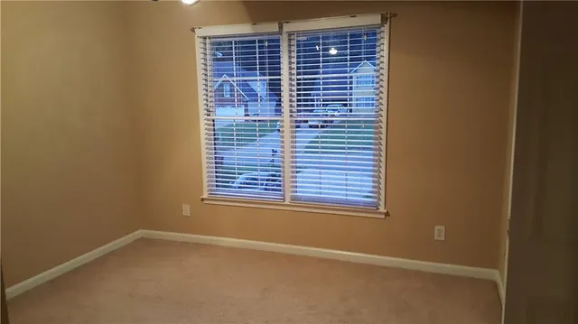 a view of an empty room with windows
