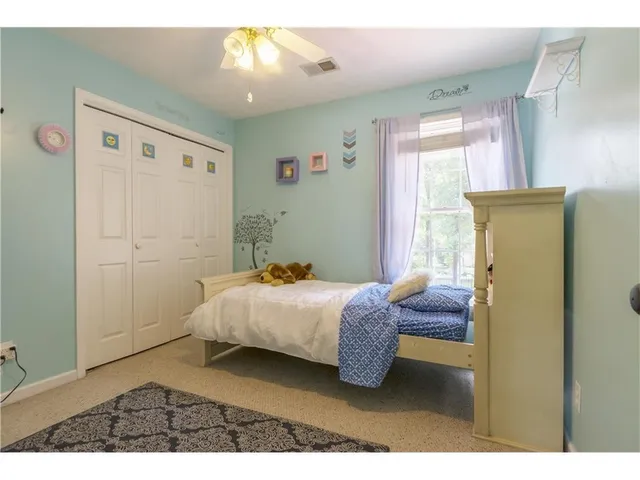 a bedroom with a bed and a cabinets
