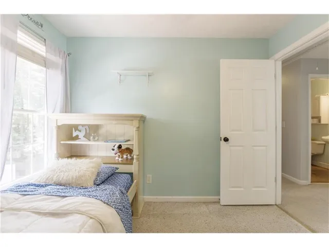a bedroom with furniture and a window