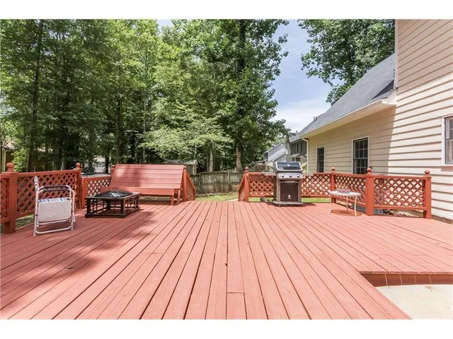 a view of a dining room with furniture a chandelier and wooden floor