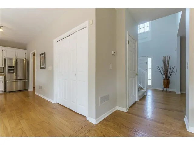 a view of a hallway view with wooden floor and staircase