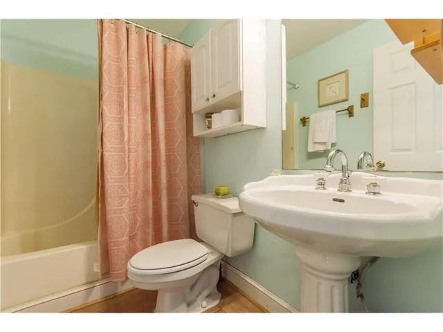 a kitchen with stainless steel appliances white cabinets and a refrigerator