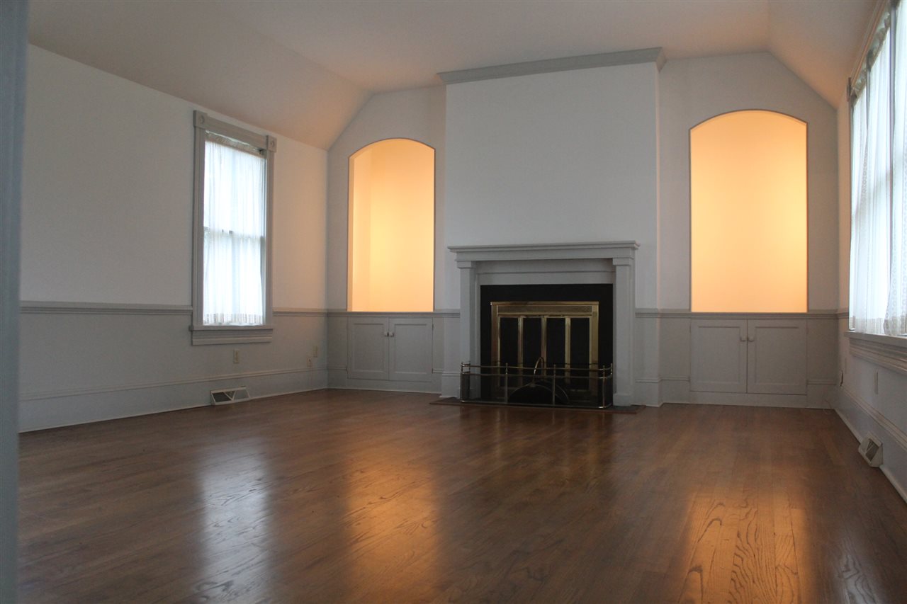 352 Beautiful Run Road Rochelle, VA 22738 - Photo 8 of 35 an empty room with wooden floor a fireplace and windows