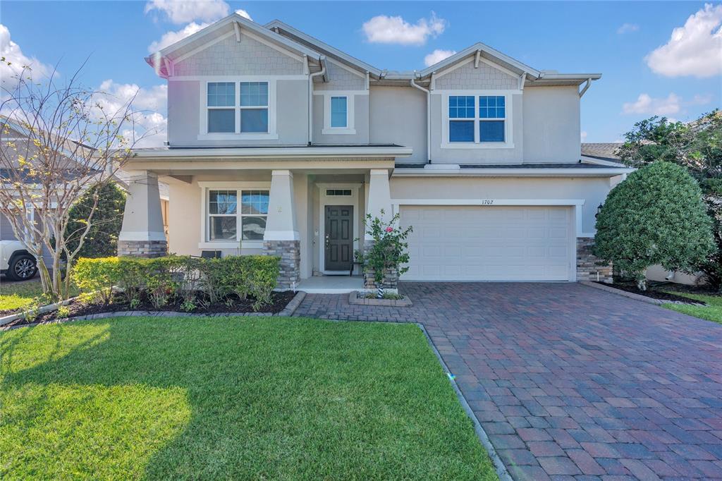 1702 Reflection Lane St. Cloud, FL 34771 - Photo 1 of 1 a front view of a house with a yard and garage