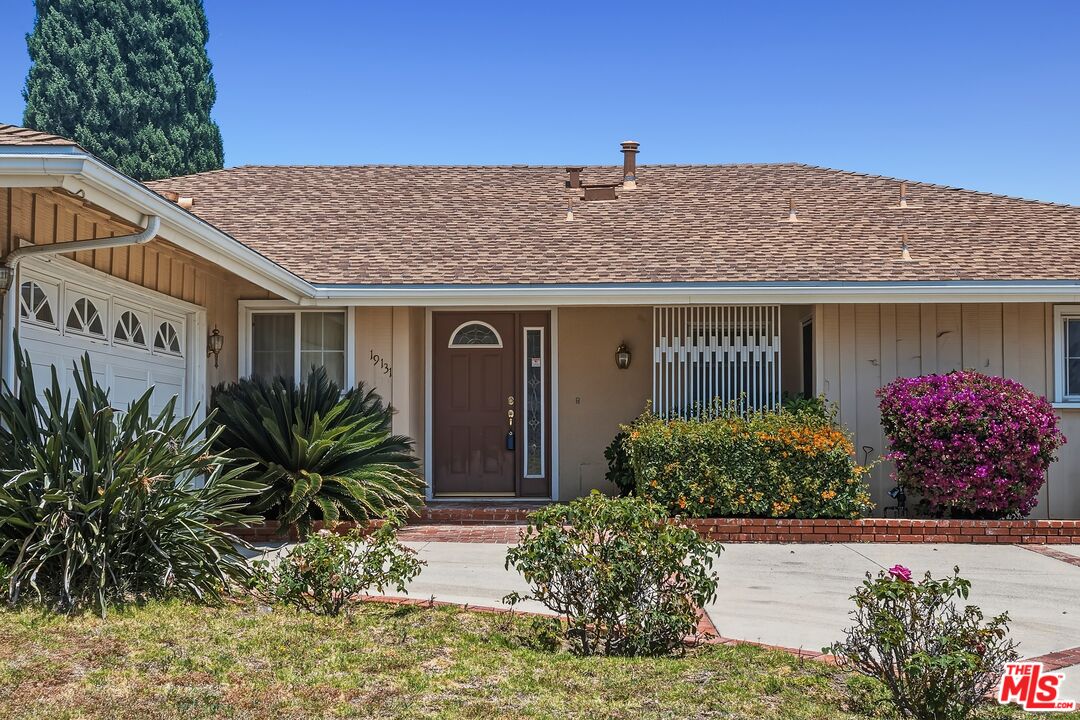 19131 Tulsa Street Porter Ranch, CA 91326 - Photo 4 of 43 a view of a house with a flower garden