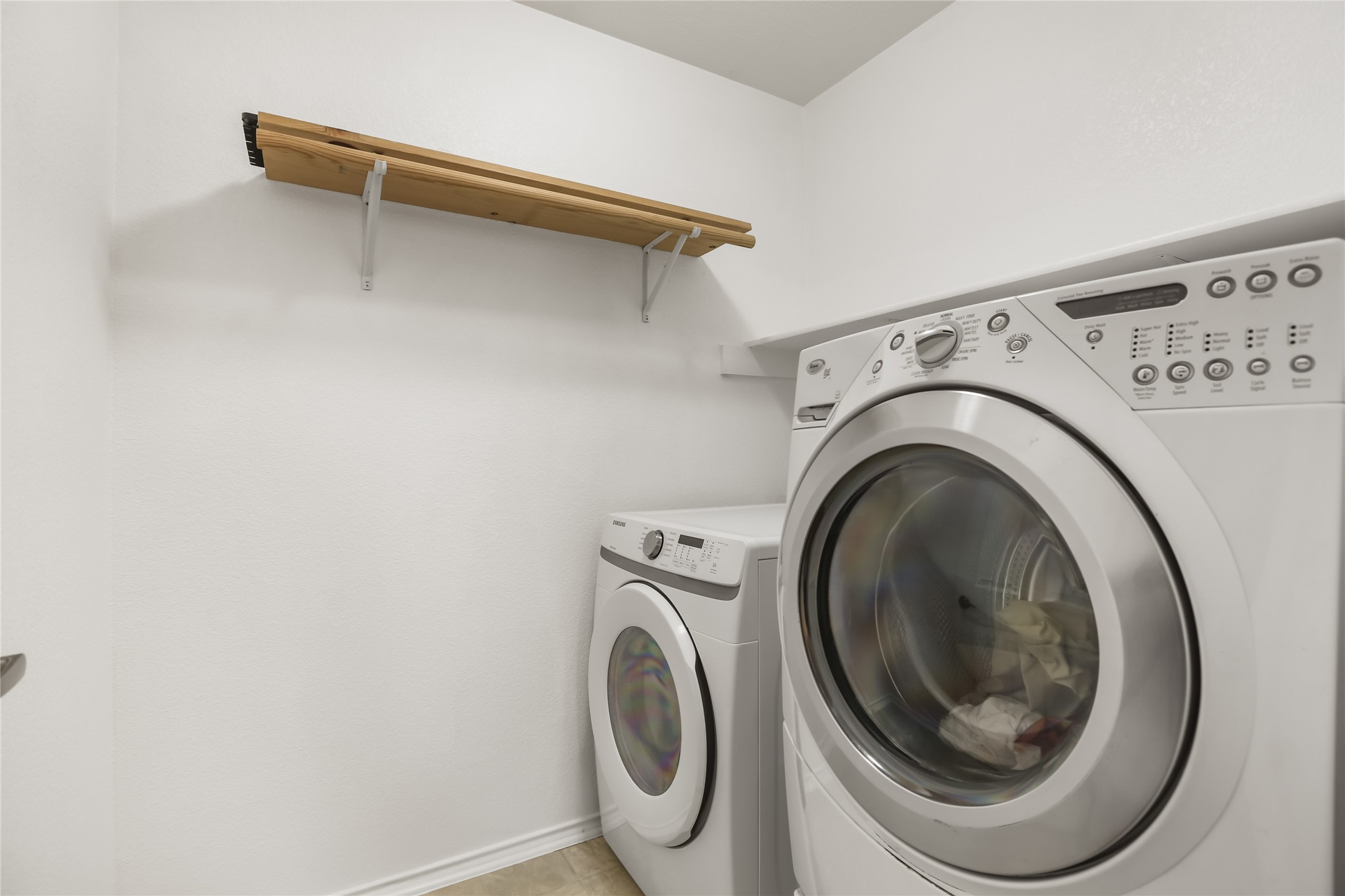 2010 Ashberry Trail Georgetown, TX 78626 - Photo 17 of 24 Laundry room featuring washing machine and dryer and baseboards