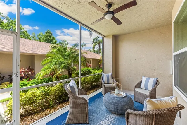 a outdoor living space with furniture potted plant and a large window