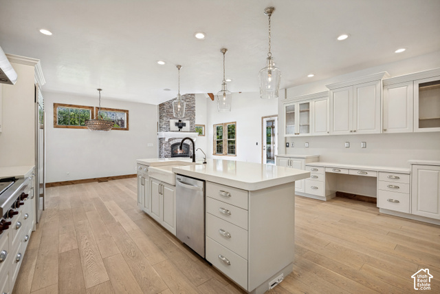 259 Twin River Loop Alpine, UT 84004 - Photo 8 of 61 Expansive kitchen featuring a large island with an integrated farmhouse sink, light wood-finish flooring, recessed lighting, and built-in white cabinetry for organizing every kitchen item.