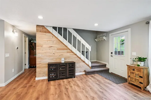 a view of entryway with wooden floor and windows