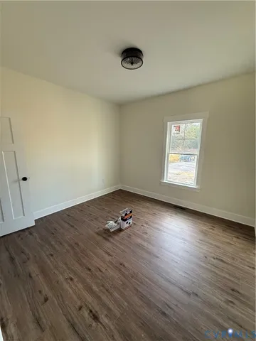a very nice looking room with wooden floor and a ceiling fan