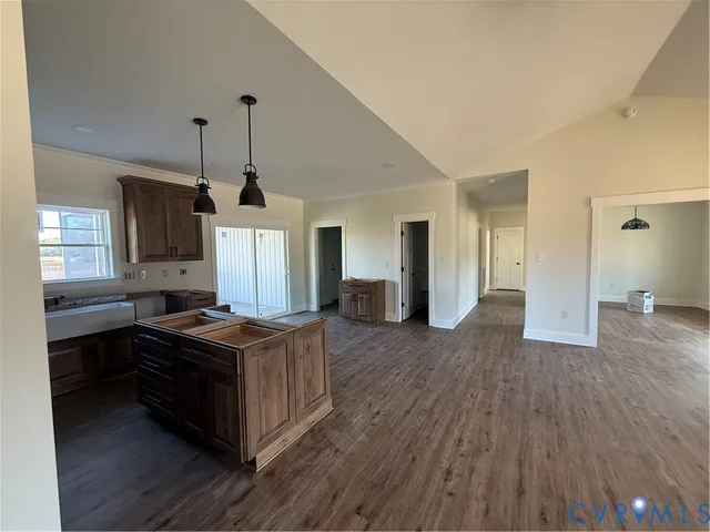 a kitchen with stainless steel appliances granite countertop a sink stove and wooden floors