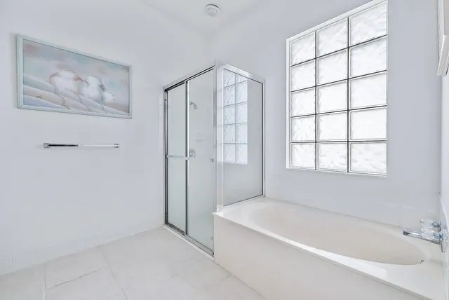 a bathroom with a bathtub and a shower