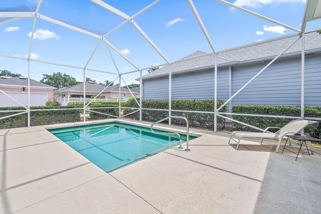 a view of a house with a backyard and a patio