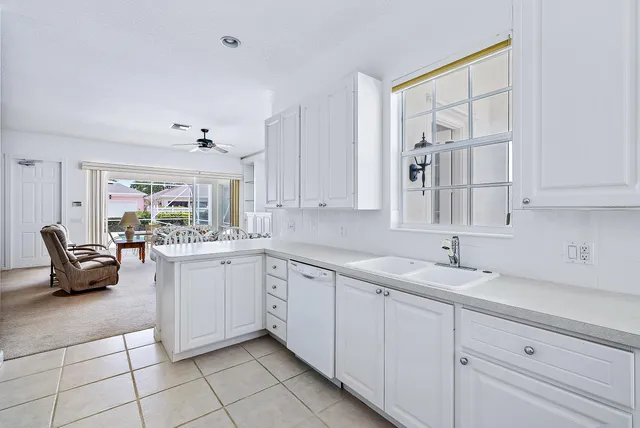 a kitchen with sink and cabinets