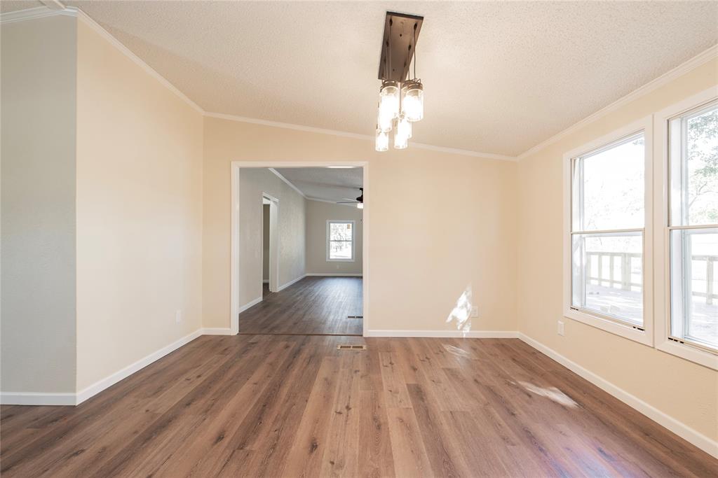 667 Rs County Road 1503 Point, TX 75472 - Photo 13 of 38 a view of empty room with wooden floor and fan