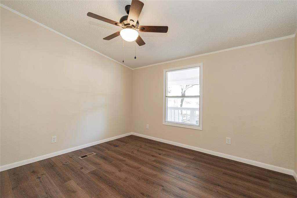 667 Rs County Road 1503 Point, TX 75472 - Photo 19 of 38 an empty room with wooden floor fan and windows