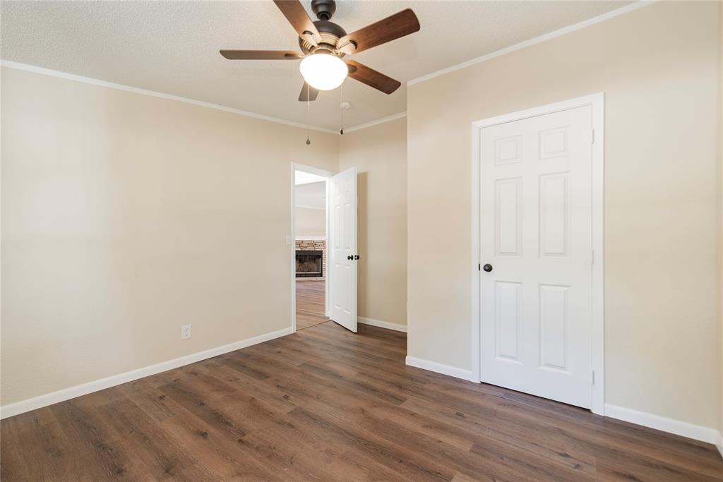 667 Rs County Road 1503 Point, TX 75472 - Photo 20 of 38 an empty room with wooden floor and ceiling fan
