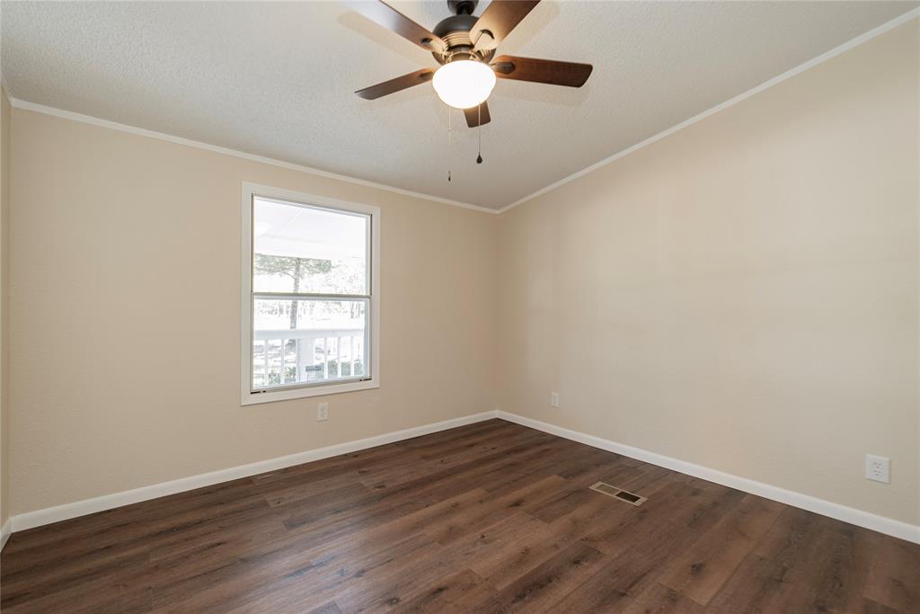 667 Rs County Road 1503 Point, TX 75472 - Photo 21 of 38 wooden floor in an empty room with a window
