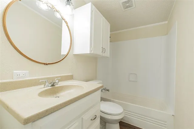 a bathroom with a sink toilet and a mirror