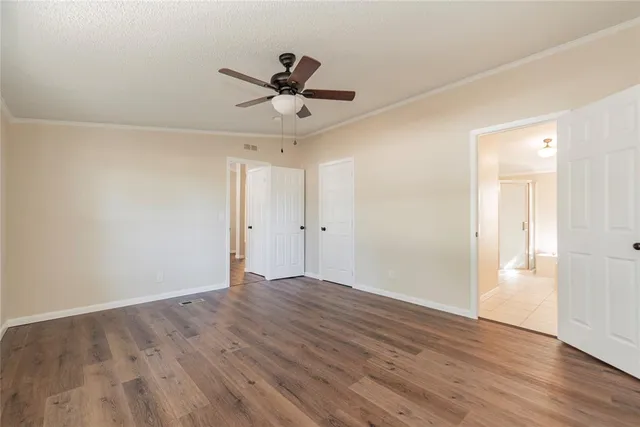 a view of an empty room and wooden floor