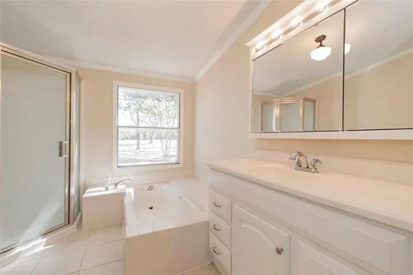 a bathroom with a bathtub a sink and a window